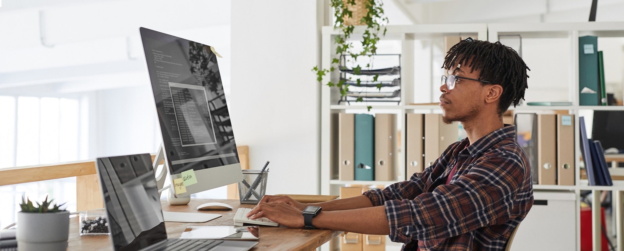Tech associate working on code at computer