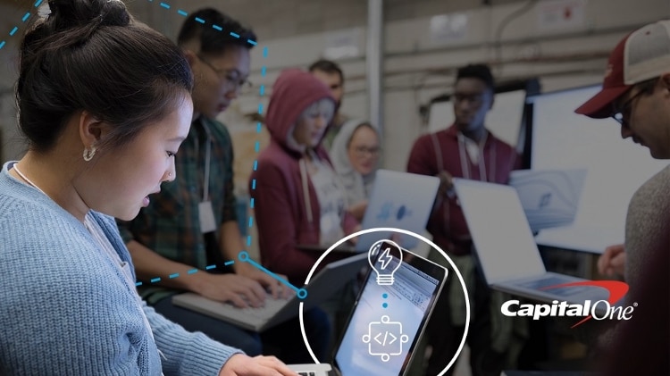 group of developers with open computers, with white lightbulb and white and blue dotted circle and hexagon overlayed on top, and capital one logo in bottom right corner
