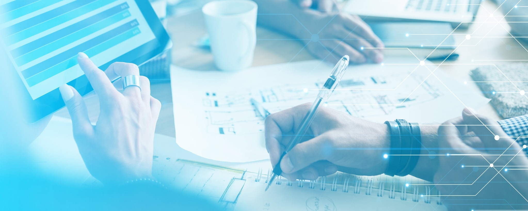 close up of a woman and man's hands working. woman's hands are selecting something on a touch screen with blue and navy rows nad man's hands are holding a black pen and writing on a spiral notebook. there is a light blue image treatment over the whole image and white and blue geometric lines with dots overlaid as well