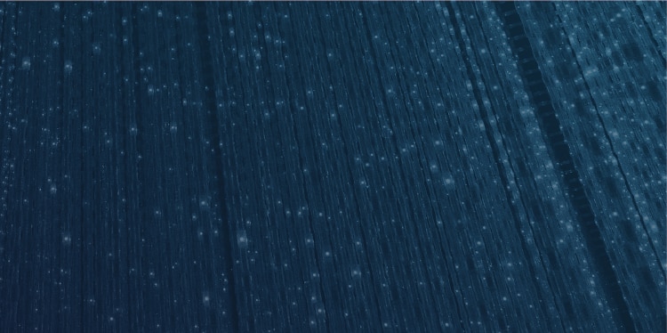 Long white lights illuminating dark navy background
