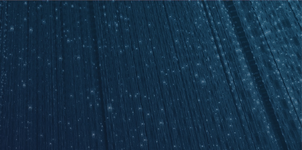 Long white lights illuminating dark navy background