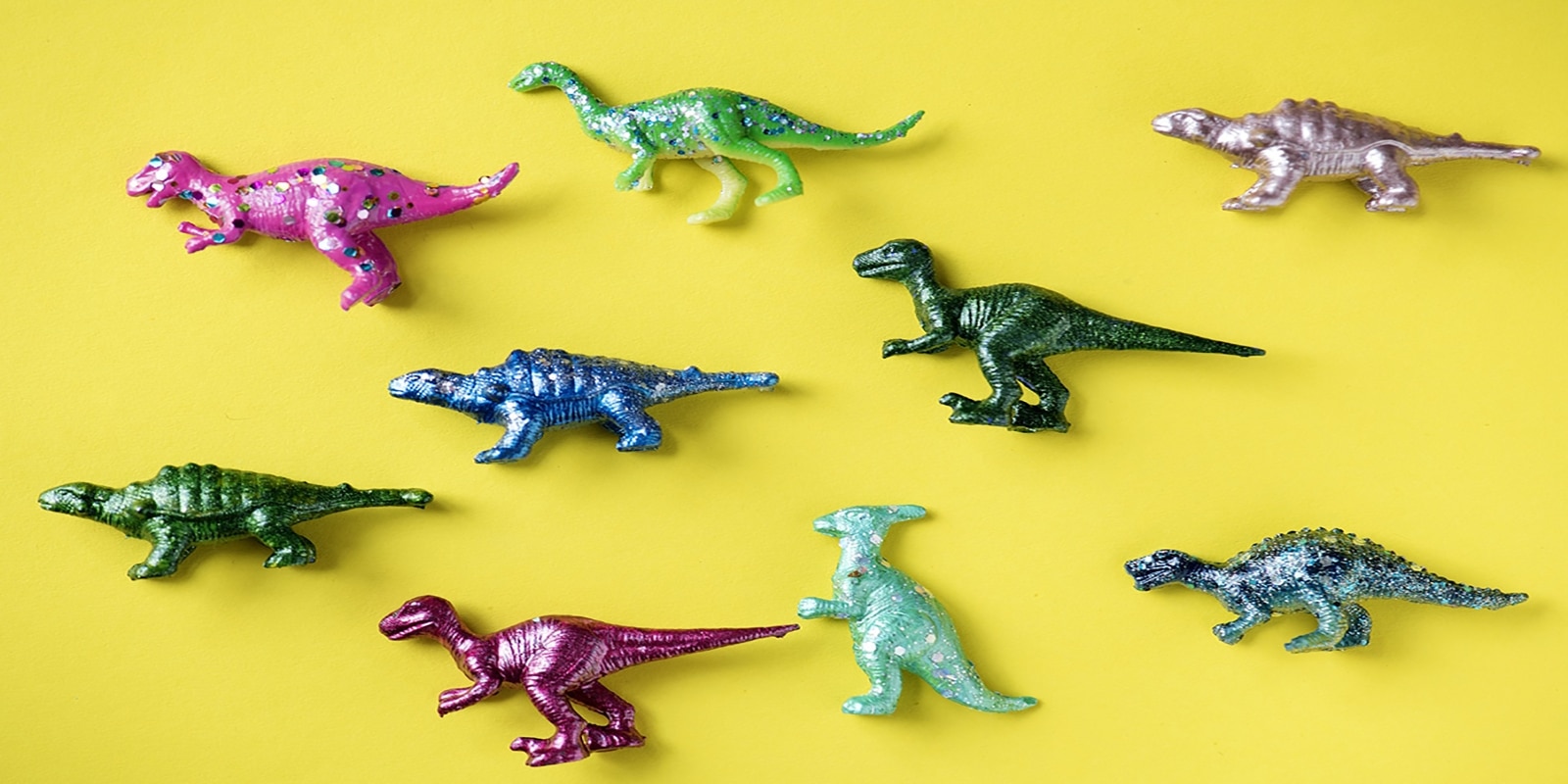 colorful dinosaur figures with yellow background