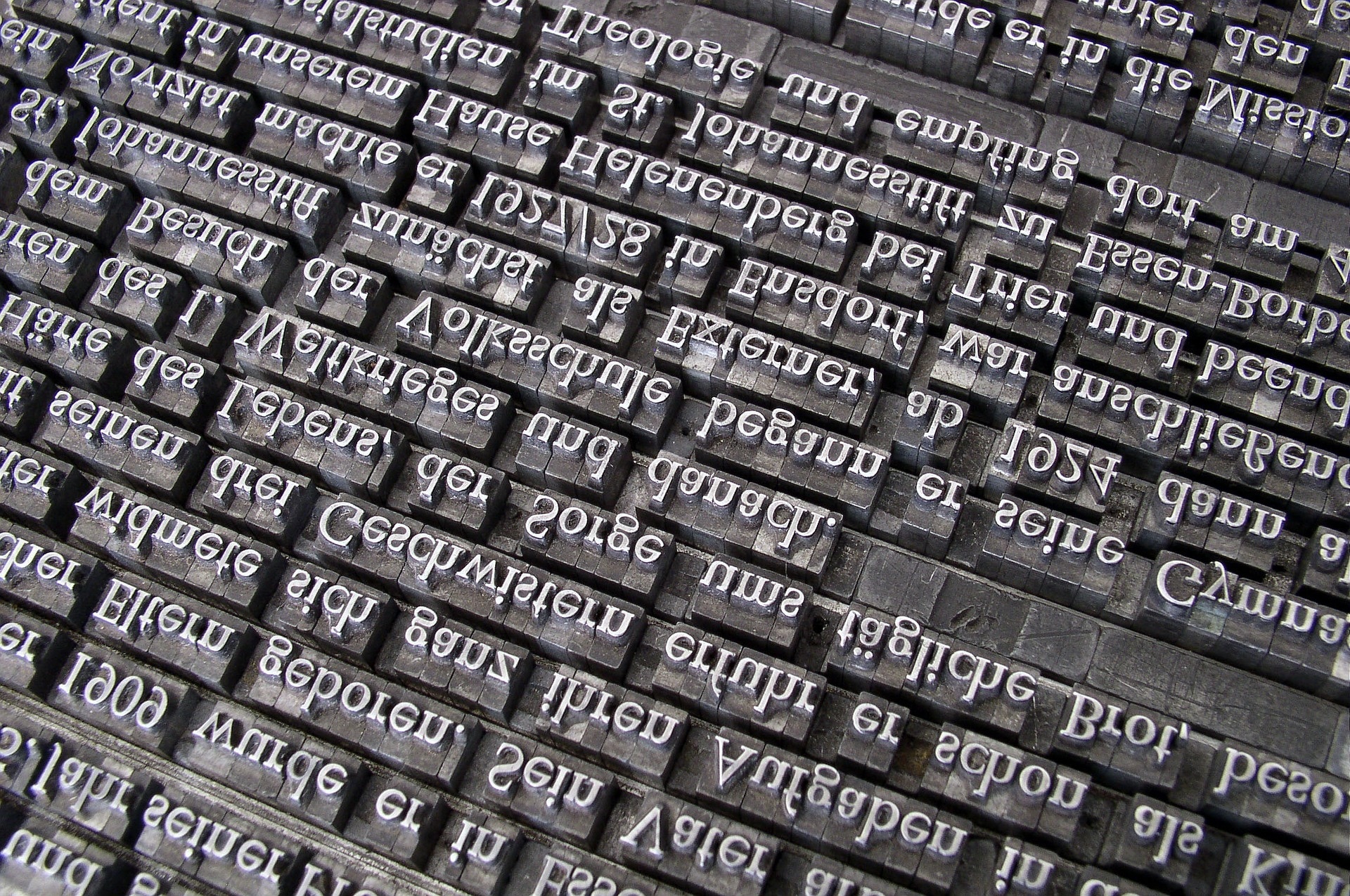 upside down stainless steel printing press keys with white text