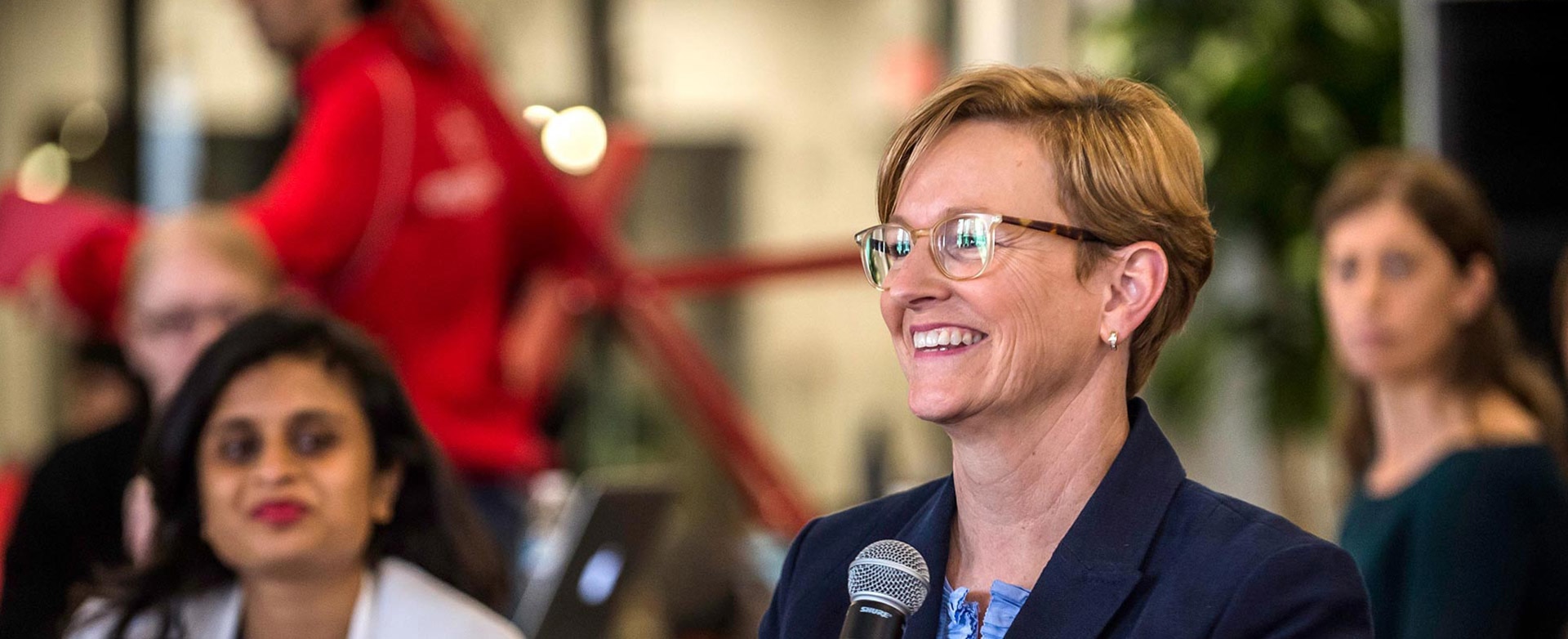 julie elberfield smiling in forground and three women in behind her