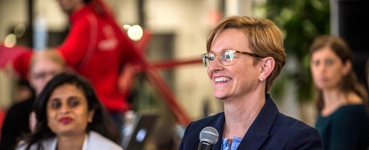 julie elberfield smiling in forground and three women in behind her