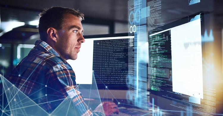 man staring at 2 computer screens