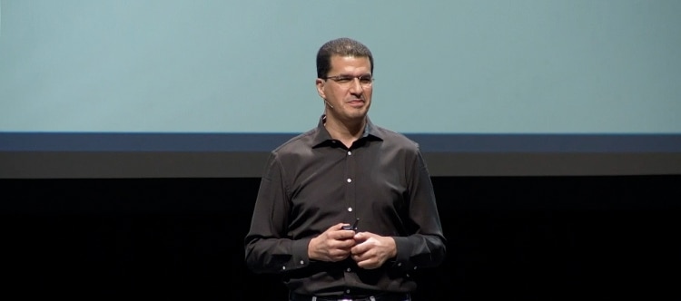 man in brown shirt giving lecture
